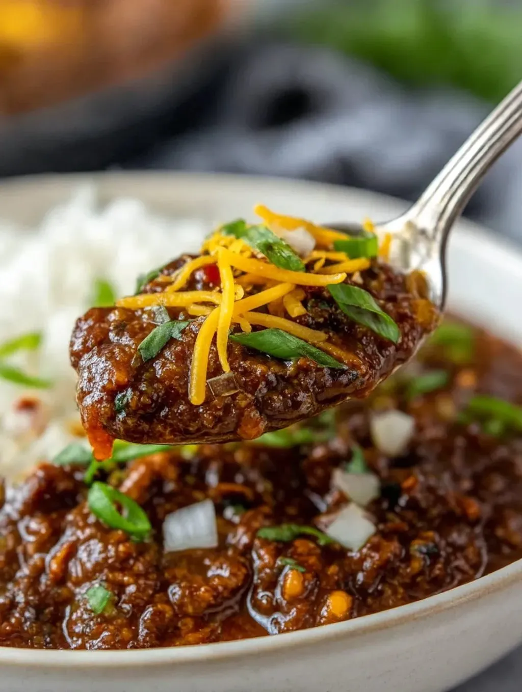 Ein Schalen mit Koreanischem Chile Con Carne wird mit einer Gabel gegriffen.