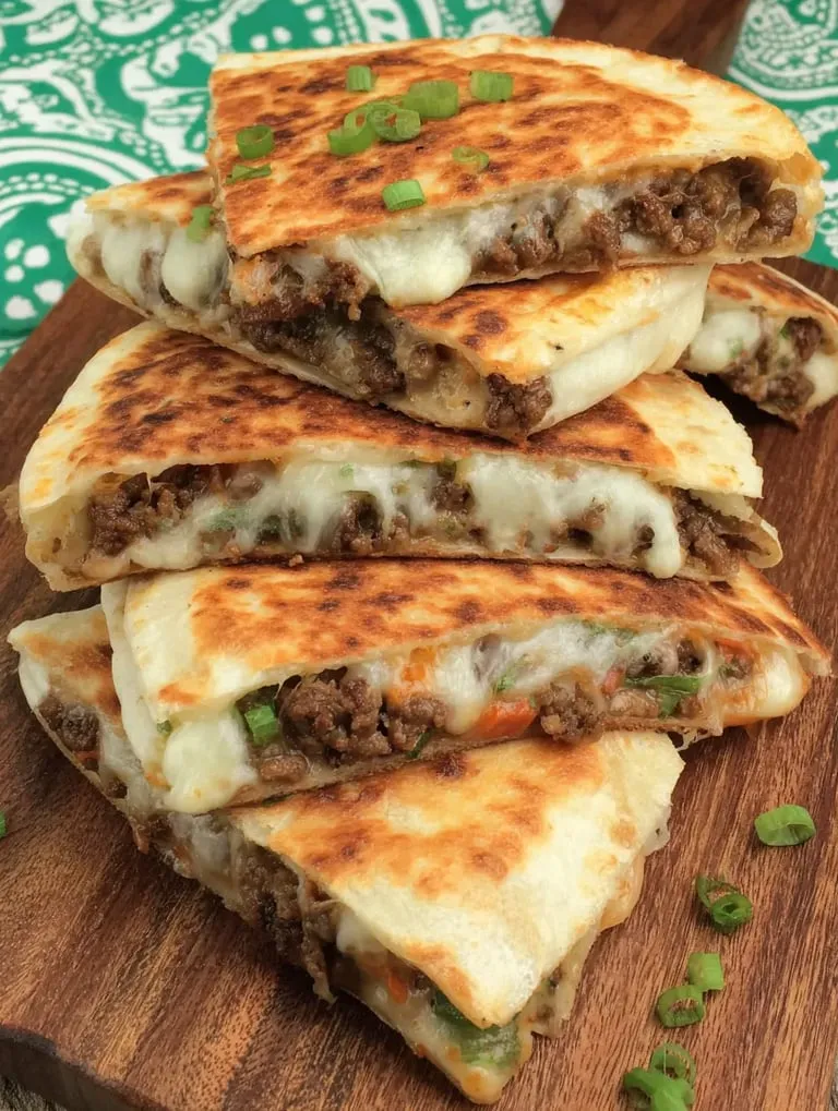 Eine Schicht aus Käse und Rindfleisch auf einer Tortilla.