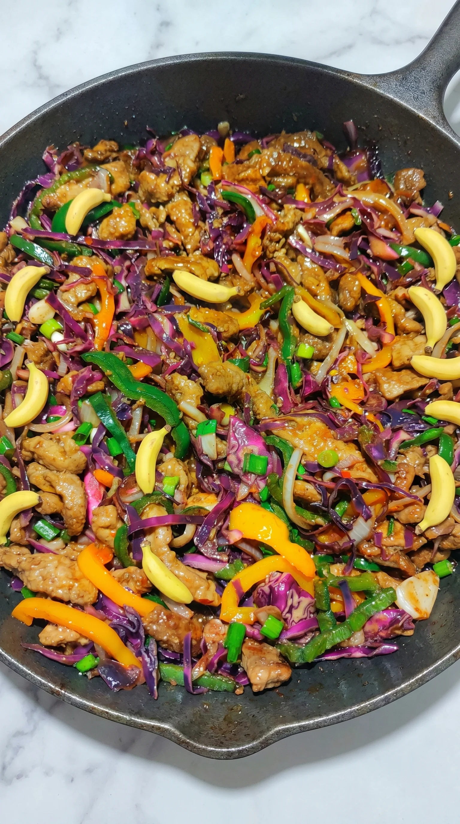 A dish of meat and vegetables, including peppers and onions.