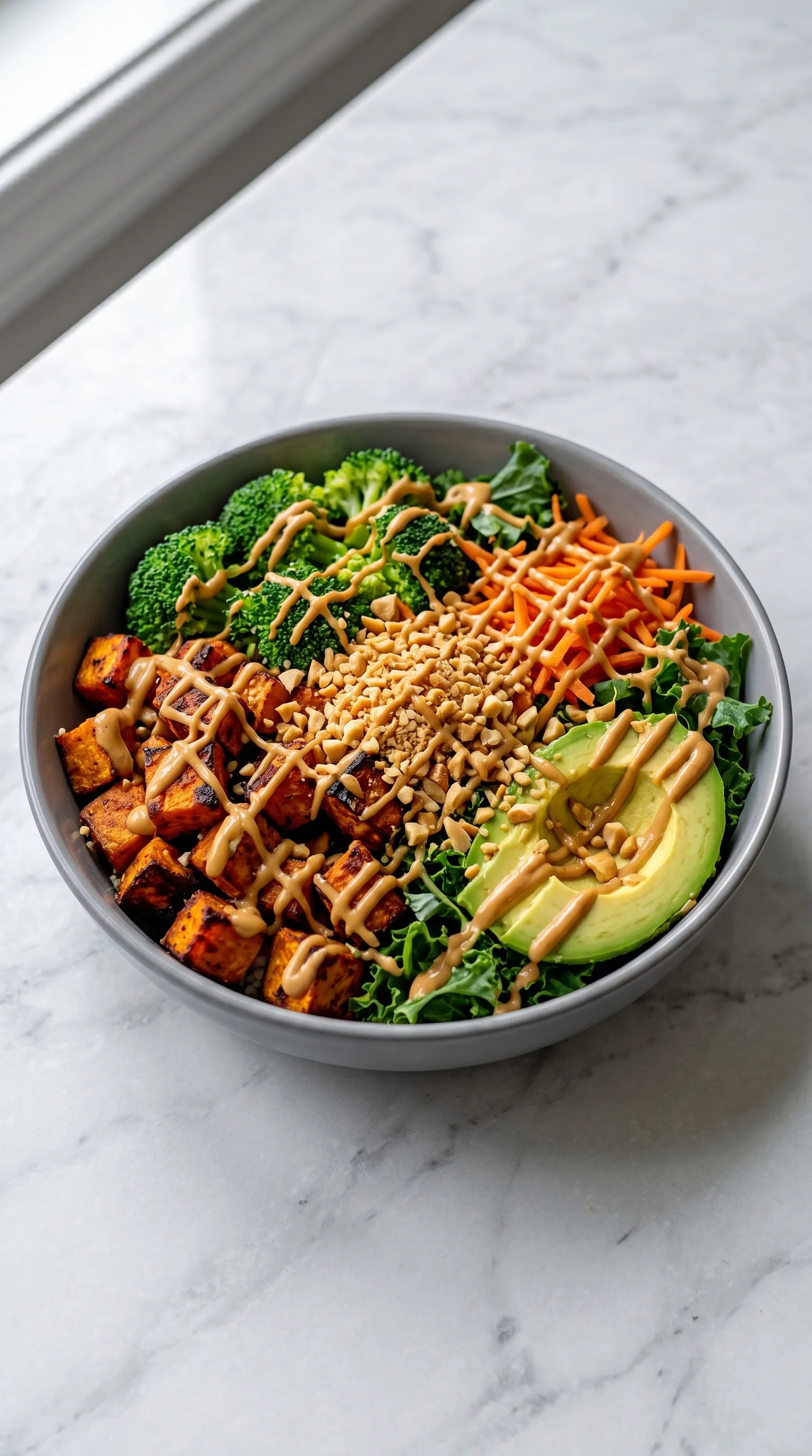 A bowl of food with a variety of ingredients, including broccoli, carrots, and avocado.