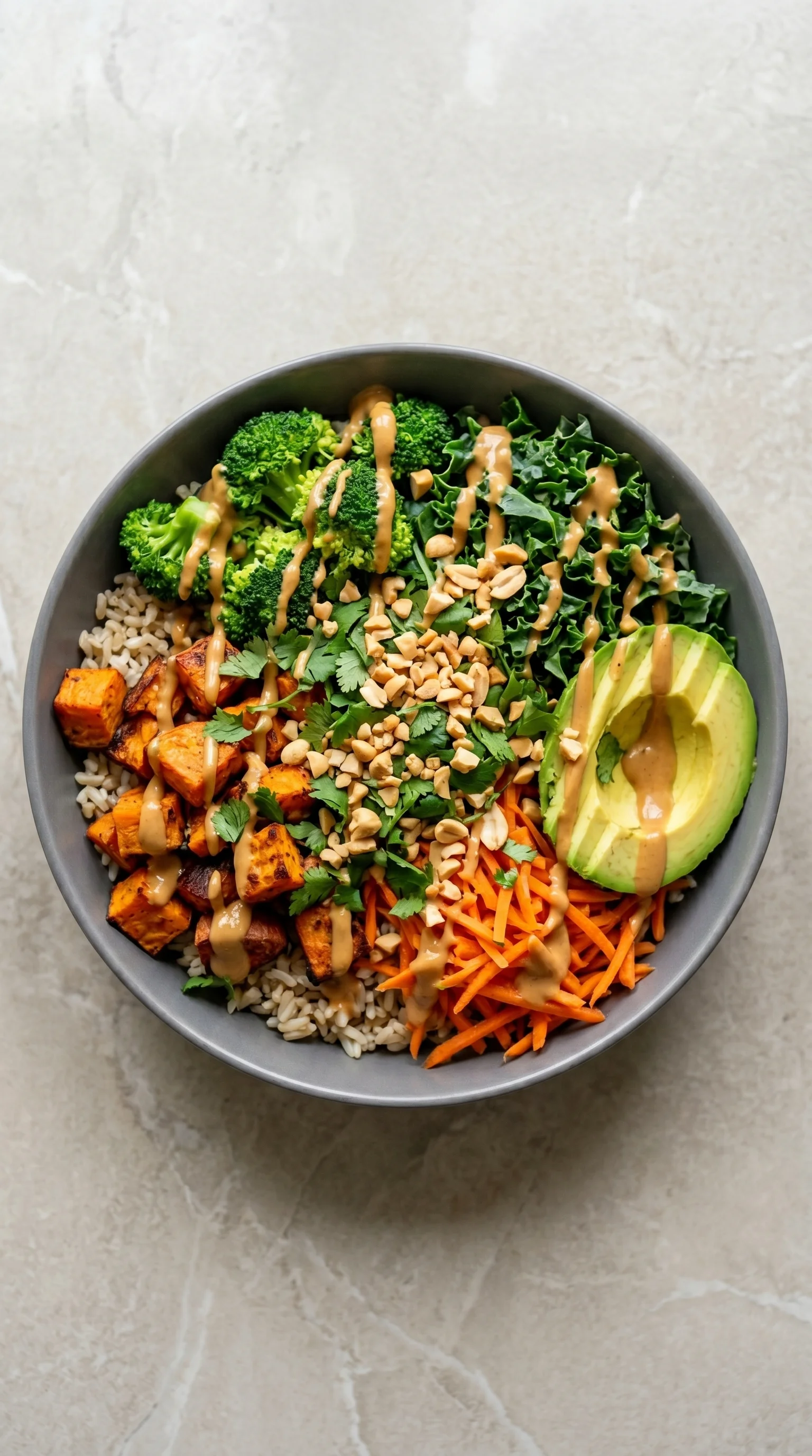 A bowl of food with a variety of ingredients including carrots, broccoli, and nuts.