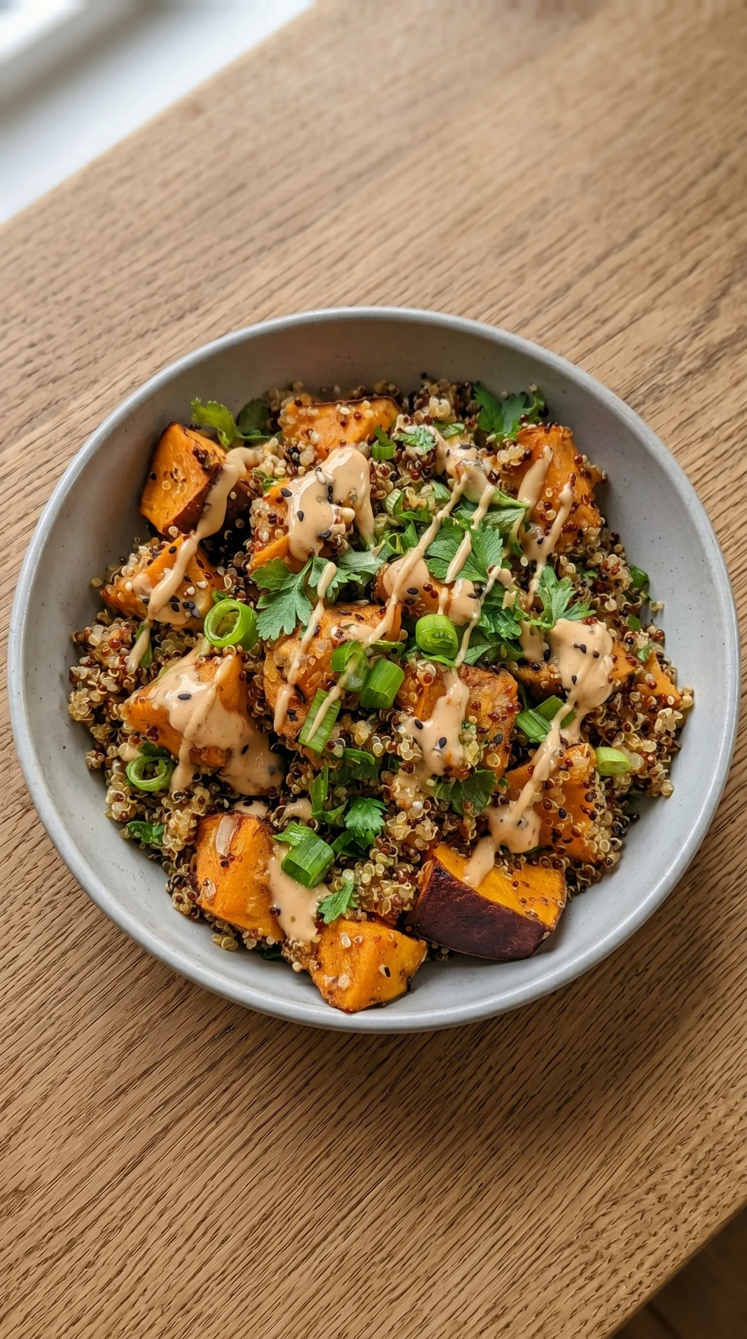 A bowl of food with a sauce on top.