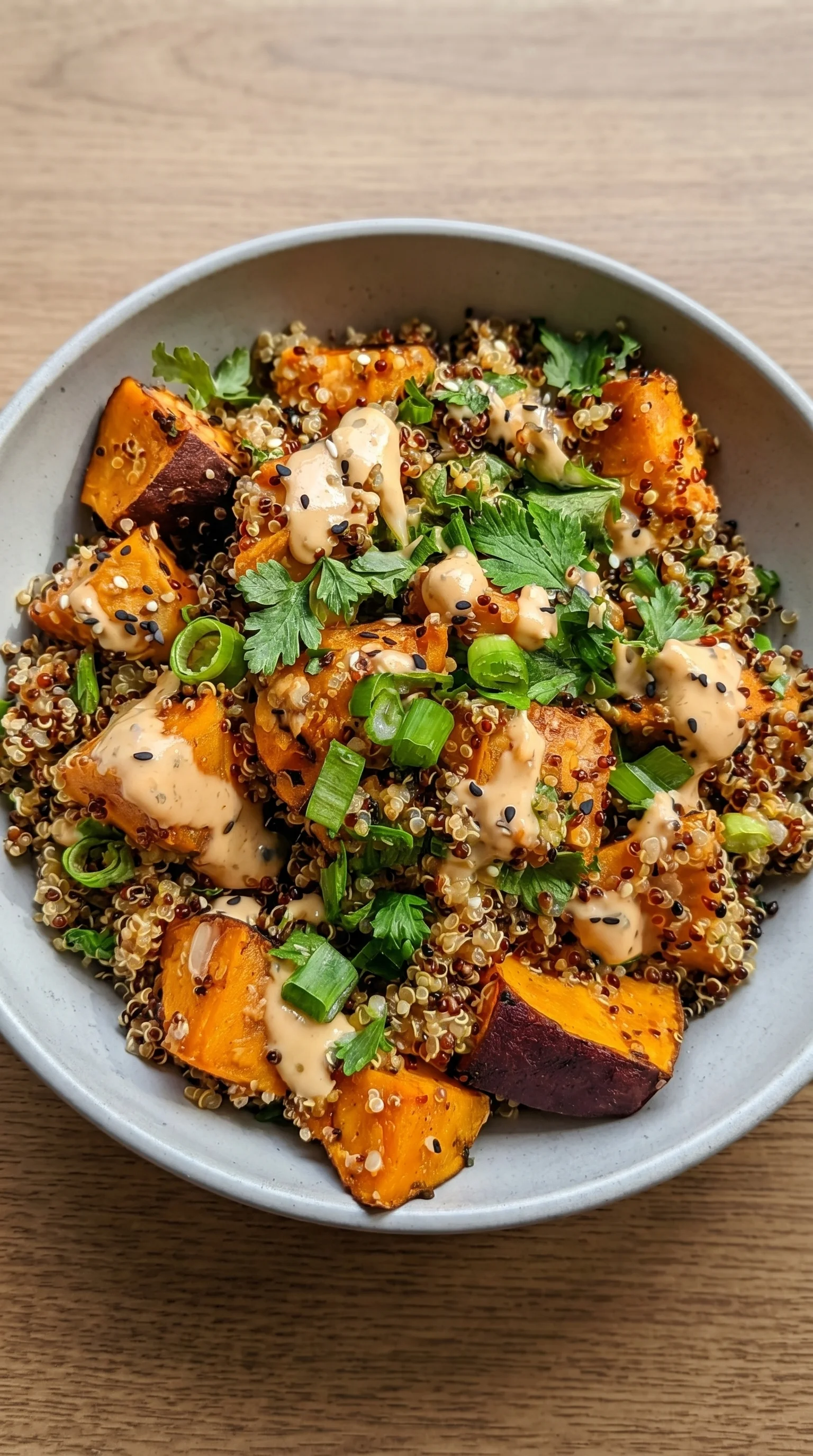 A bowl of food with a sauce on top.
