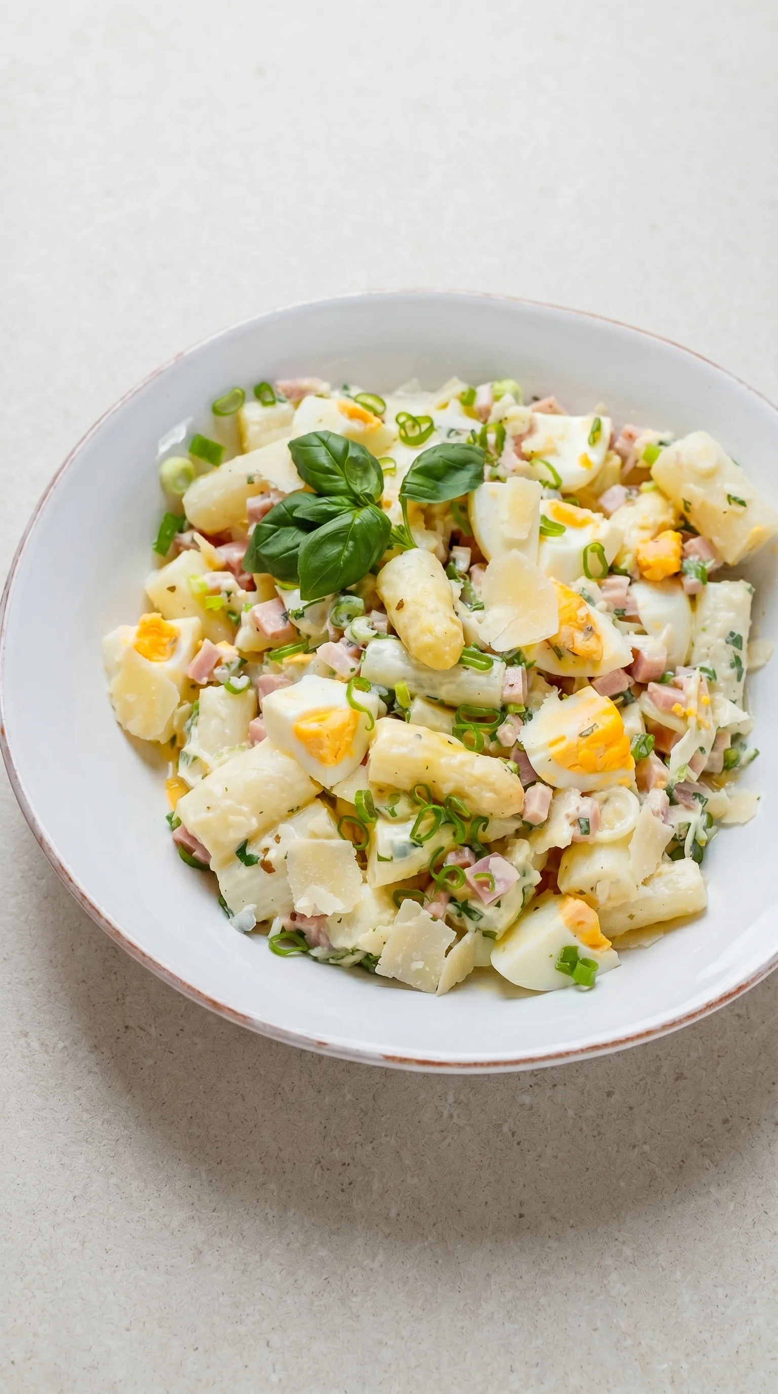 A bowl of food with eggs and ham.
