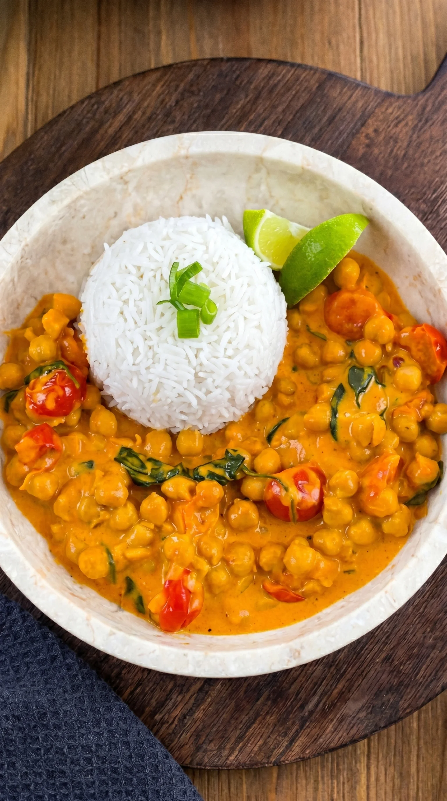 A bowl of food with rice and tomatoes.